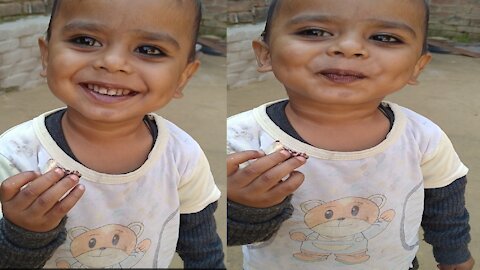 Village baby eating chocolate funny