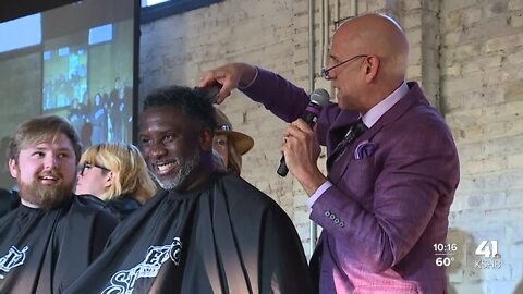 Gary Lezak helps shave Kevin Holmes’ head at Shave to Save cancer event