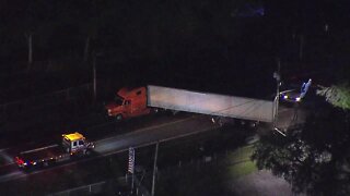 Sedan crashes into, gets stuck under tractor-trailer; minor injuries report