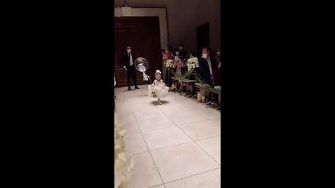 how cute baby girl serve ring basket to the couple
