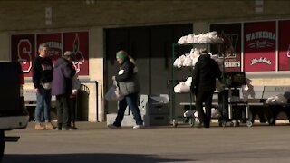 Kitchen staff at Waukesha South smile as they hand out meals to families