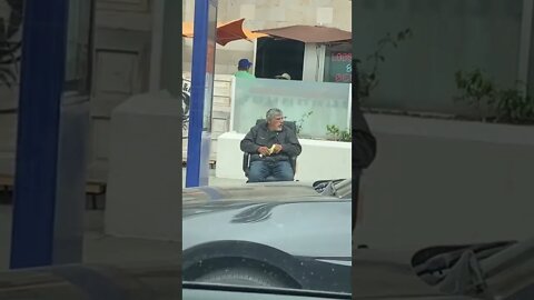 Man Brings His Chair To The Bus Stop