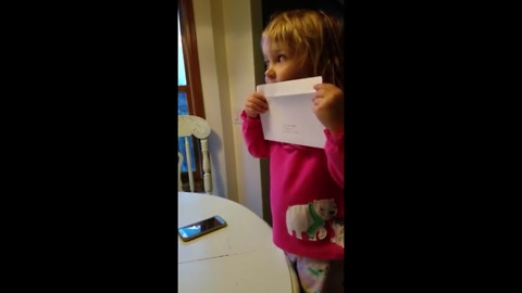 Enthusiastic toddler prepares Christmas cards