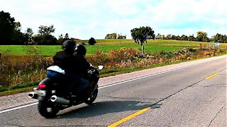 Motorcycle accelerates to intentionally buzz past cyclist at very high speed