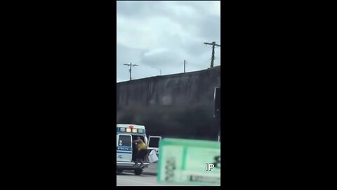 Woman leaps from and escapes a moving ambulance on crowded Los Angeles freeway