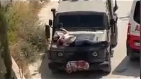 Israeli regime's troops tie a wounded man to a hood of their armored vehicle as human shield