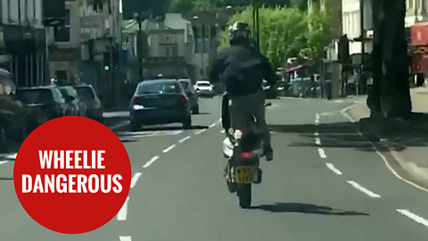 Moped rider wheelies down the wrong side of busy main road