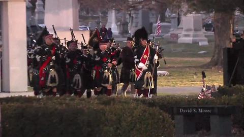 Bagpipes play as the hearse carrying Dep. Jacob Pickett arrives at Crown Hill Cemetery