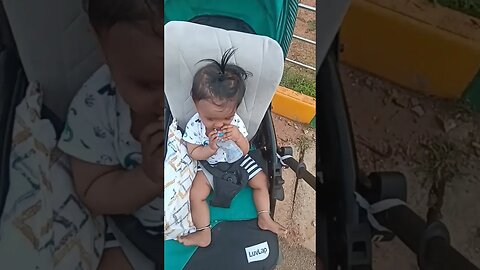 8 months old baby is drinking water after playing