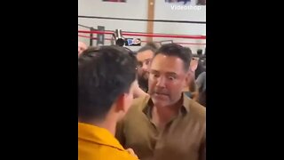 Oscar De La Hoya looks focused talking to Ryan Garcia