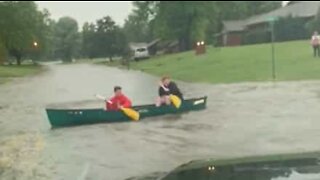 Youth canoe on street during storm!