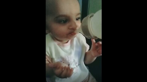 Baby eating apple puree for first time-- funny reaction