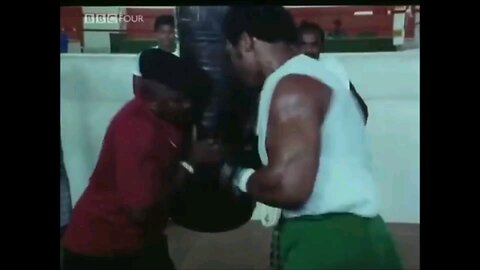 'BIG' George Foreman punched a whole in the heavy bag and sends trainer flying...