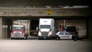 Semi truck stuck under I-94 bridge on Mitchell Blvd.