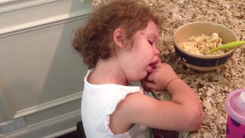 "Toddler Girl Falls Asleep and Snores on Kitchen Table"