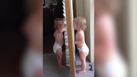 "Twin Toddler Girls Pretending To Be Each Other's Mirror Image"