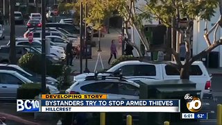 Bystanders try to stop armed thieves