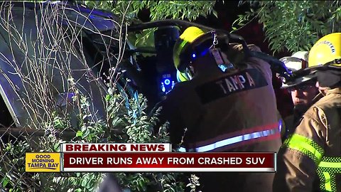 Police search for driver who ran away from crash leaving female passenger pinned in SUV