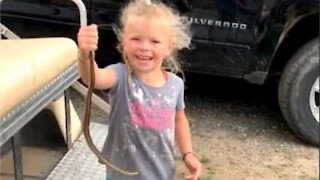 Menina de 5 anos captura cobra com as mãos