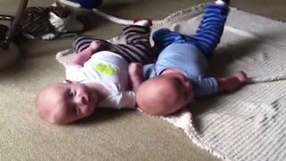 "Baby Twins Roll Over and Kick Same Leg"