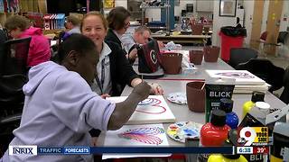 High school art students help adult artists with disabilities