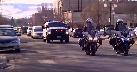 Kittitas Deputy Ryan Thompson escorted by a long line of law enforcement to funeral home
