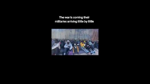 Military Aged Illegal Immigrants Line the Broken Border Wall