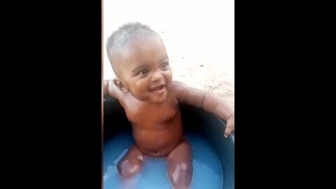 Cute funny baby smile for the first time while taking bath