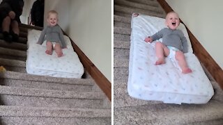 Fearless Toddler Slides Down The Stairs On A Mattress