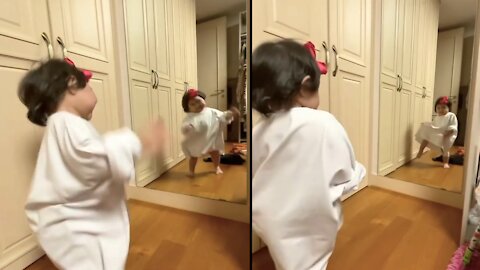 Dancing baby loses it in Mirror when favorite song is played