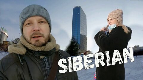 I'm walking in Siberia, looking at people, buildings and trains. Lenin Street and Main station.