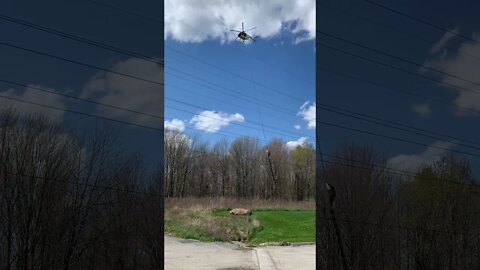 Trimming trees with a helicopter.