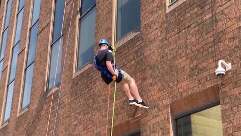 FirstEnergy employees rappel down building to support Boy Scouts of America