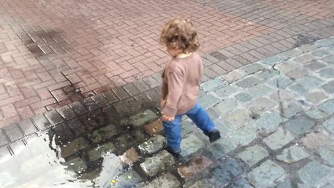 Toddler discovers a puddle, knows exactly what to do!