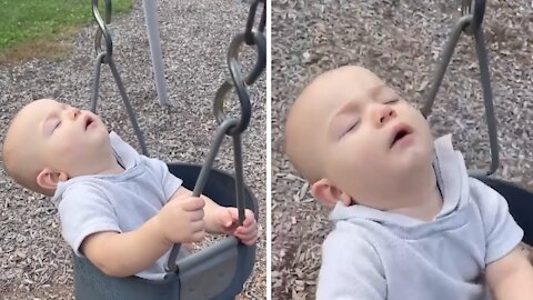 Drowsy baby takes a nap during swing ride