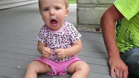 A Tot Girl Makes Silly Faces When She Hears Firecrackers Pop Off