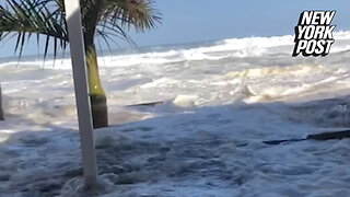 Biblical wave crashes into beachfront restaurant