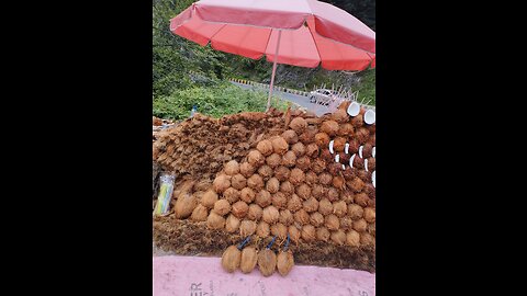 "Revealing the Art of Fresh Coconut Opening: A Roadside Delight!"