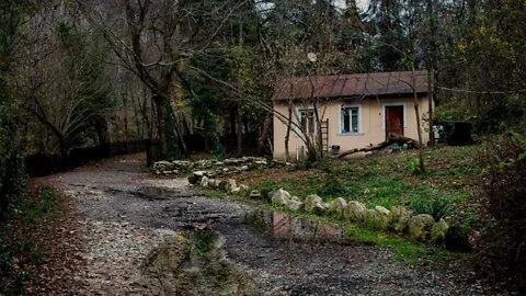 Rain on a gravel path by a small lonely house near Sochi, Russia