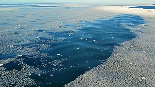 Grand Marais, MI - Aerial Footage of the Waves & Ice Along the Shore of Lake Superior.