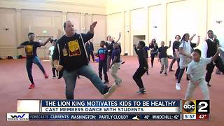 The Lion King cast members dance with local kids