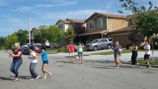 Neighbors dance first conga line to respect social distancing