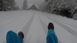 First snow - sledding on cardboard with plastic bag