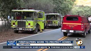Firefighters work to protect homes