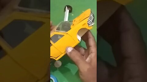 MINIATURE YELLOW TOY CAR