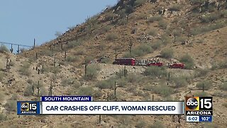 Car crashes off cliff, woman rescued