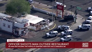 Phoenix officer shoots man who was holding two people at gunpoint