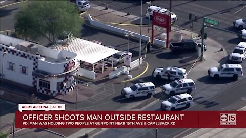 Phoenix officer shoots man who was holding two people at gunpoint