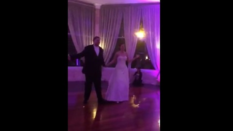 Bride and groom perform choreographed first dance