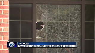 Woman injured, strip mall damaged in crash in Wixom